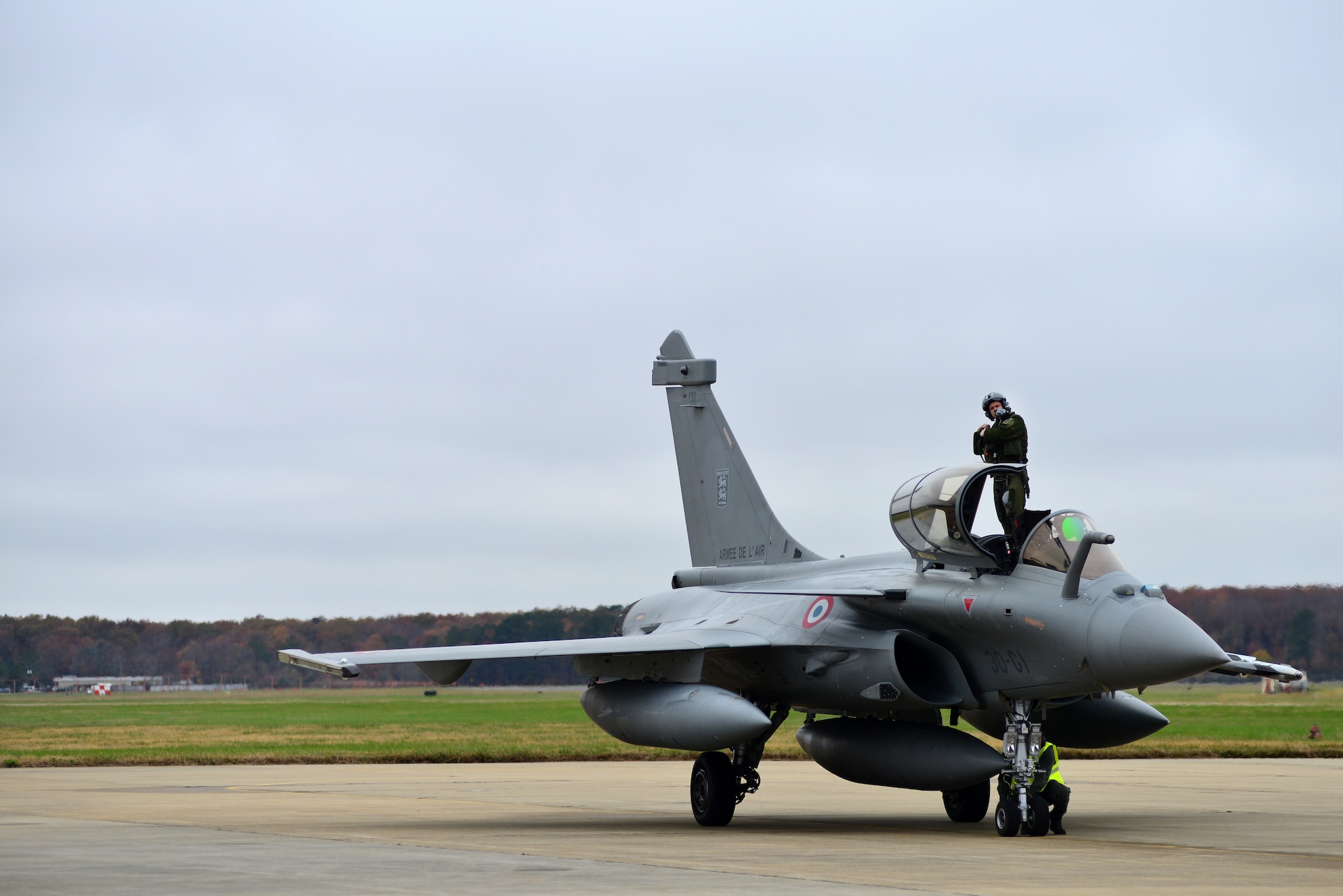 A French air force (FrAF) pilot exits a Rafale prior to the inaugural Trilateral Exercise, at Langley Air Force Base, Va., Dec. 1, 2015. The FrAF Rafales, U.S. Air Force F-22 Raptors and British Royal Air Force Typhoons will participate in a variety of scenarios taking place over water during daylight hours. (U.S. Air Force photo by Senior Airman Aubrey White)