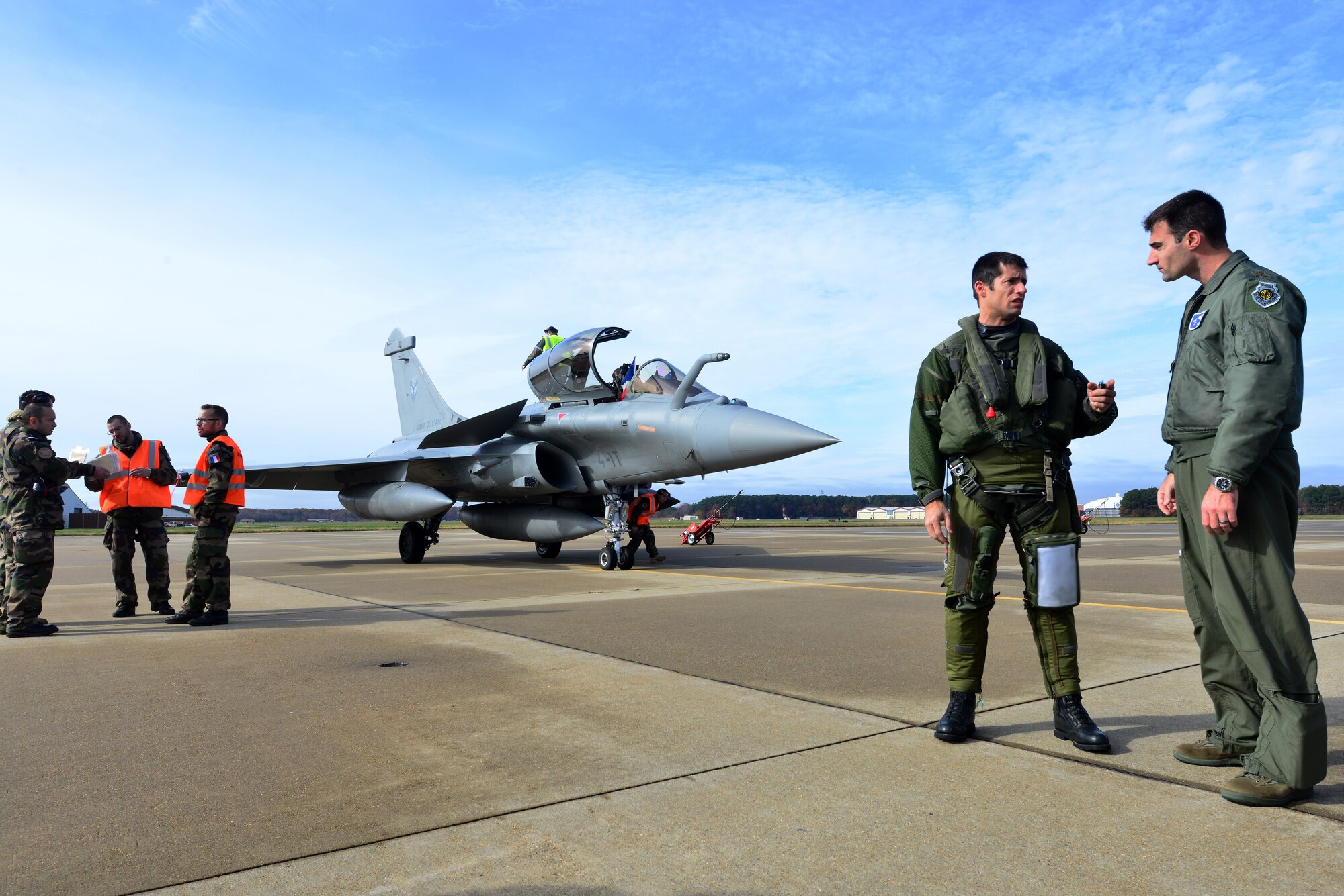 Members of the U.S. and French air forces speak before the inaugural Trilateral Exercise, at Langley Air Force Base, Va., Dec. 1, 2015. The exercise, hosted by the 1st Fighter Wing, primarily features the French Rafale, F-22 Raptor and the British Royal Air Force Typhoon. (U.S. Air Force photo by Senior Airman Aubrey White)