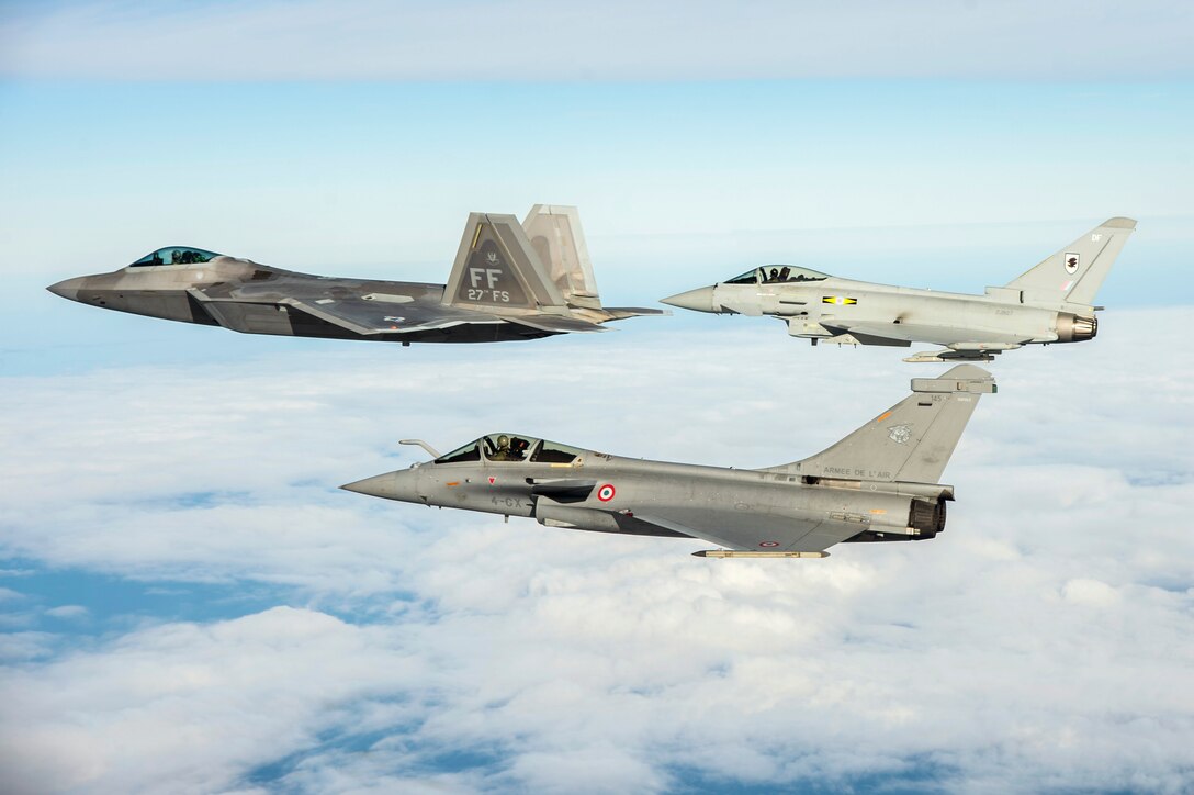 A U.S. Air Force F-22 Raptor, British Royal Air Force Typhoon, and French air force Rafale fly in formation as part of a Trilateral Exercise held at Langley Air Force Base, Va., Dec. 7, 2015. The exercise simulates a highly-contested, degraded and operationally-limited environment where U.S. and partner pilots and ground crews can test their readiness. (U.S. Air Force photo by Senior Airman Kayla Newman)