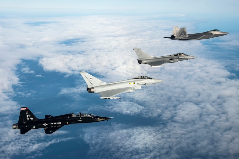 A U.S. Air Force T-38 Talon, British Royal Air Force Typhoon, French air force Rafale and U.S. Air Force F-22 Raptor fly in formation as part of a Trilateral Exercise held at Langley Air Force Base, Va., Dec. 7, 2015. The 1st Fighter Wing hosted the exercise which focuses on operations in a highly-contested operational environment. (U.S. Air Force photo by Senior Airman Kayla Newman)