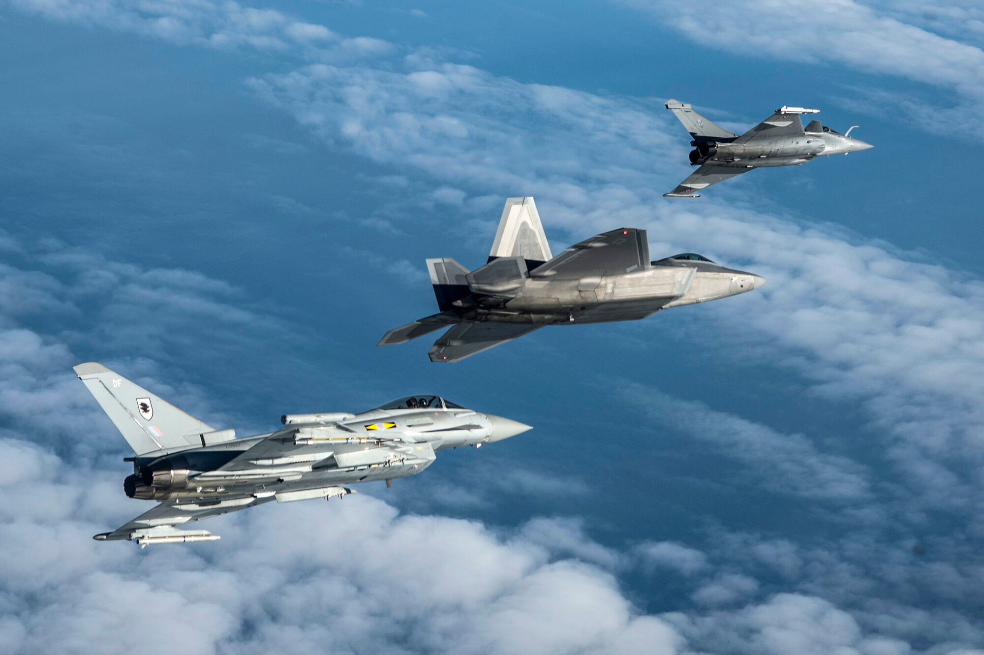 A British Royal Air Force Typhoon, U.S. Air Force F-22 Raptor and French air force Rafale fly in formation as part of a Trilateral Exercise held at Langley Air Force Base, Va., Dec. 7, 2015. The 5th generation aircraft involved in the exercise are the most technologically advanced assets in the world today. (U.S. Air Force photo by Senior Airman Kayla Newman)