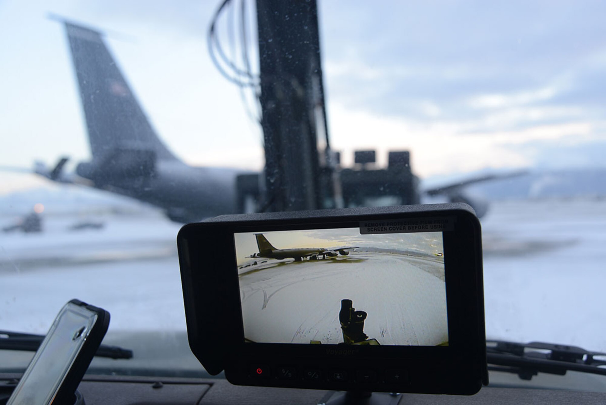 An aircraft is seen through the camera atop the deicing machine on the flight line at Joint Base Elmendorf-Richardson, Alaska, Dec. 3, 2015. The camera allows the driver to see another angle to prevent striking antennas or other equipment. (U.S. Air Force photo by Airman 1st Class Christopher R. Morales)