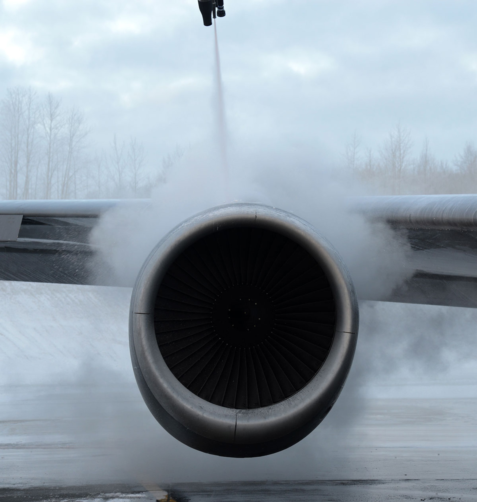 Air Force Staff Sgt. Tyler Derr, 732nd Air Mobility Squadron avionics specialist, deices a KC-135 Refueler from Air Force Base Fairchild on the flight line at Joint Base Elmendorf-Richardson, Alaska, Dec. 3, 2015. The deicing solution removed frost because it prevents the aircraft to gain any lift. (U.S. Air Force photo by Airman 1st Class Christopher R. Morales)