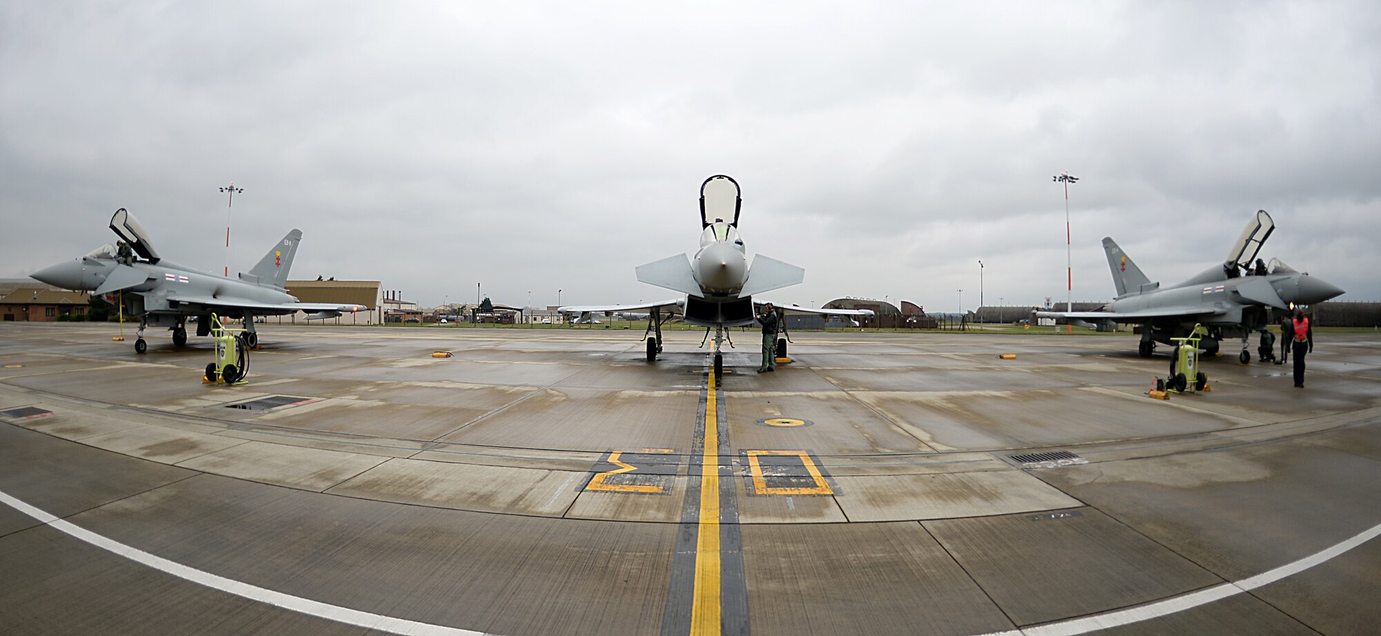 Eurofighter Typhoon pilots assigned to Royal Air Force Coningsby prepare their jets for takeoff during an exercise with the 494th Fighter Squadron at RAF Lakenheath, England, Dec. 7, 2015. Members of the 494th FS worked with the RAF pilots to strengthen U.S. Air Force interoperability with the U.K. counterparts through combat training. (U.S. Air Force photo by Staff Sgt. Emerson Nuñez/Released) 