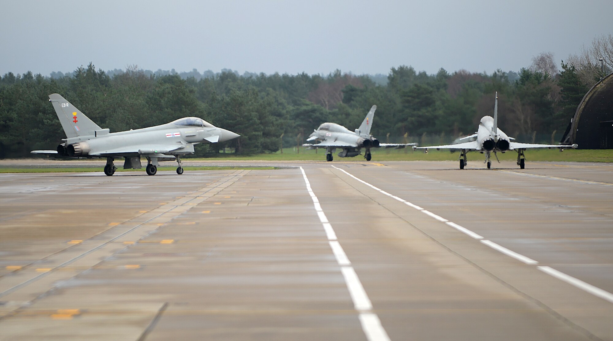 Eurofighter Typhoons assigned to Royal Air Force Coningsby taxi to the runway during an exercise with the 494th Fighter Squadron at RAF Lakenheath, England, Dec. 7, 2015. Fighter pilots from RAF Coningsby and the 494th Fighter Squadron partnered up for dissimilar air combat training where they had mock air-to-air combat fights where in this case, both aircrafts went up against each other to test each other’s and their own capabilities. (U.S. Air Force photo by Staff Sgt. Emerson Nuñez/Released) 
