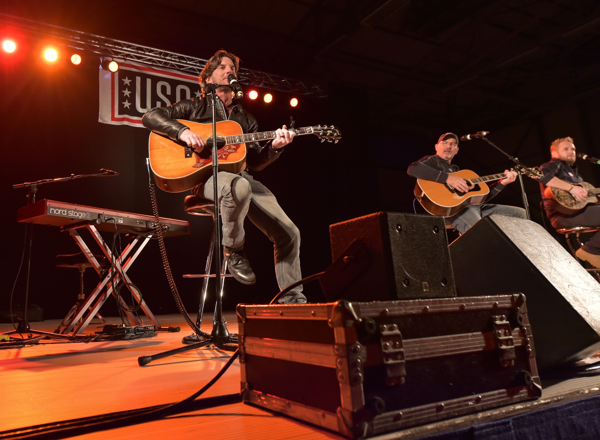 Singer and songwriter Brett James, along with Billy Montana and Kyle Jacobs, perform for the audience during the 2015 USO Holiday Troop Tour Dec. 9, 2015, at Ramstein Air Base. The entertainers gave away signed posters, movies, and other items to thank the service members and their families for their services and sacrifices. (U.S. Air Force photo/Staff Sgt. Leslie Keopka)