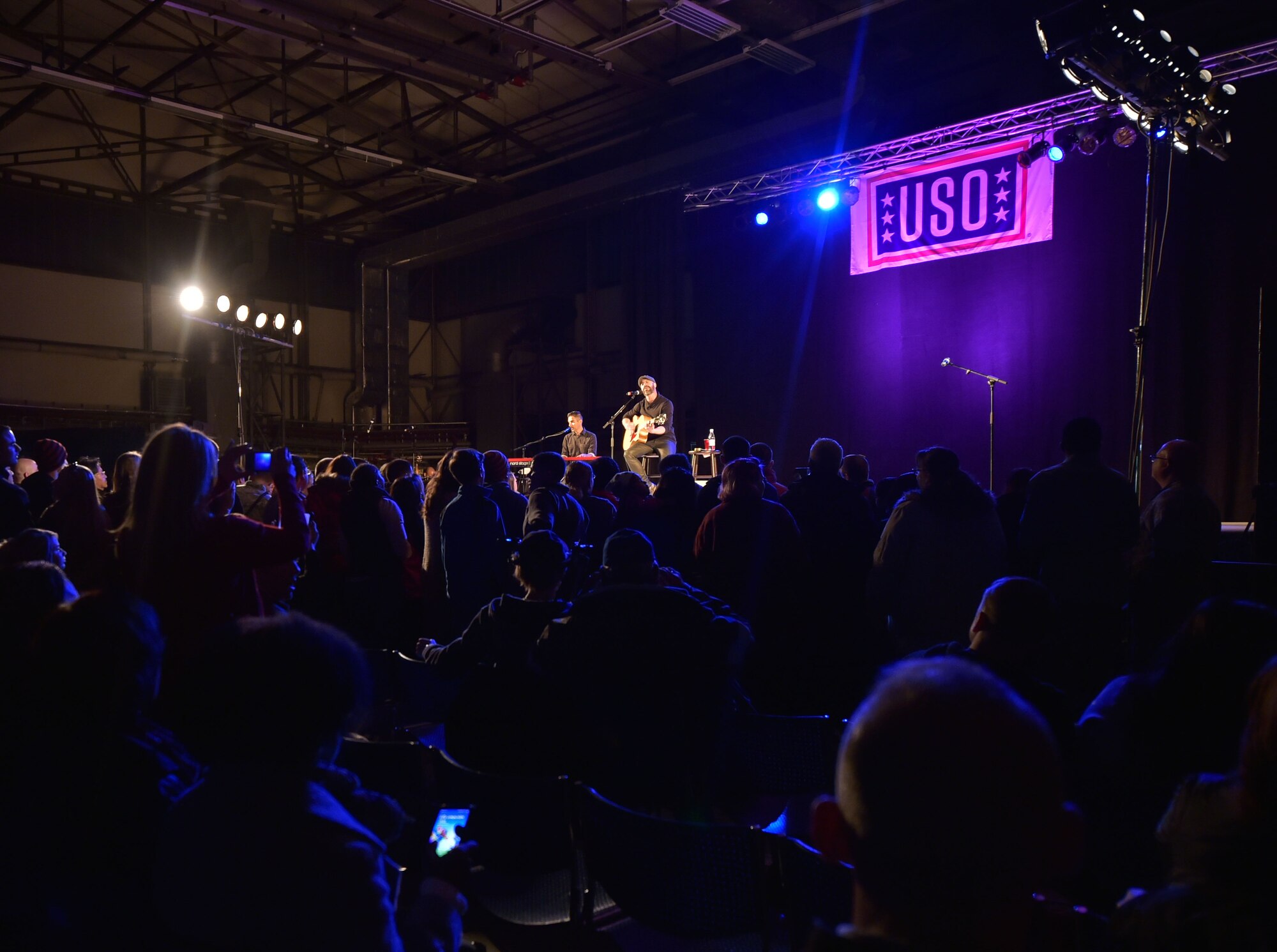 Singer Chris Daughtry performs a song during the 2015 USO Holiday Troop Tour Dec. 9, 2015, at Ramstein Air Base, Germany. Daughtry was accompanied by the Chairman of the Joint Chiefs of Staff, U.S. Marine Corps Gen. Joseph F. Dunford Jr., and other singers, songwriters, actresses and Major League Baseball players. (U.S. Air Force photo/Staff Sgt. Leslie Keopka)