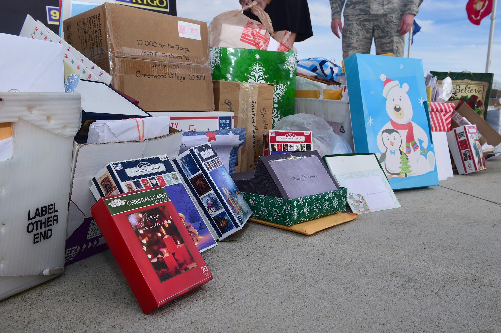 Holiday cards are displayed by Buckley First Sergeants Council members and members of Denver radio station 98.5 KYGO Dec. 9, 2015, at the Colorado Freedom Memorial in Aurora, Colo. Thousands of cards, written by residents of Denver, will be delivered to troops stationed abroad who will not be home for the holidays. (U.S. Air Force photo by Airman 1st Class Luke W. Nowakowski/Released) 