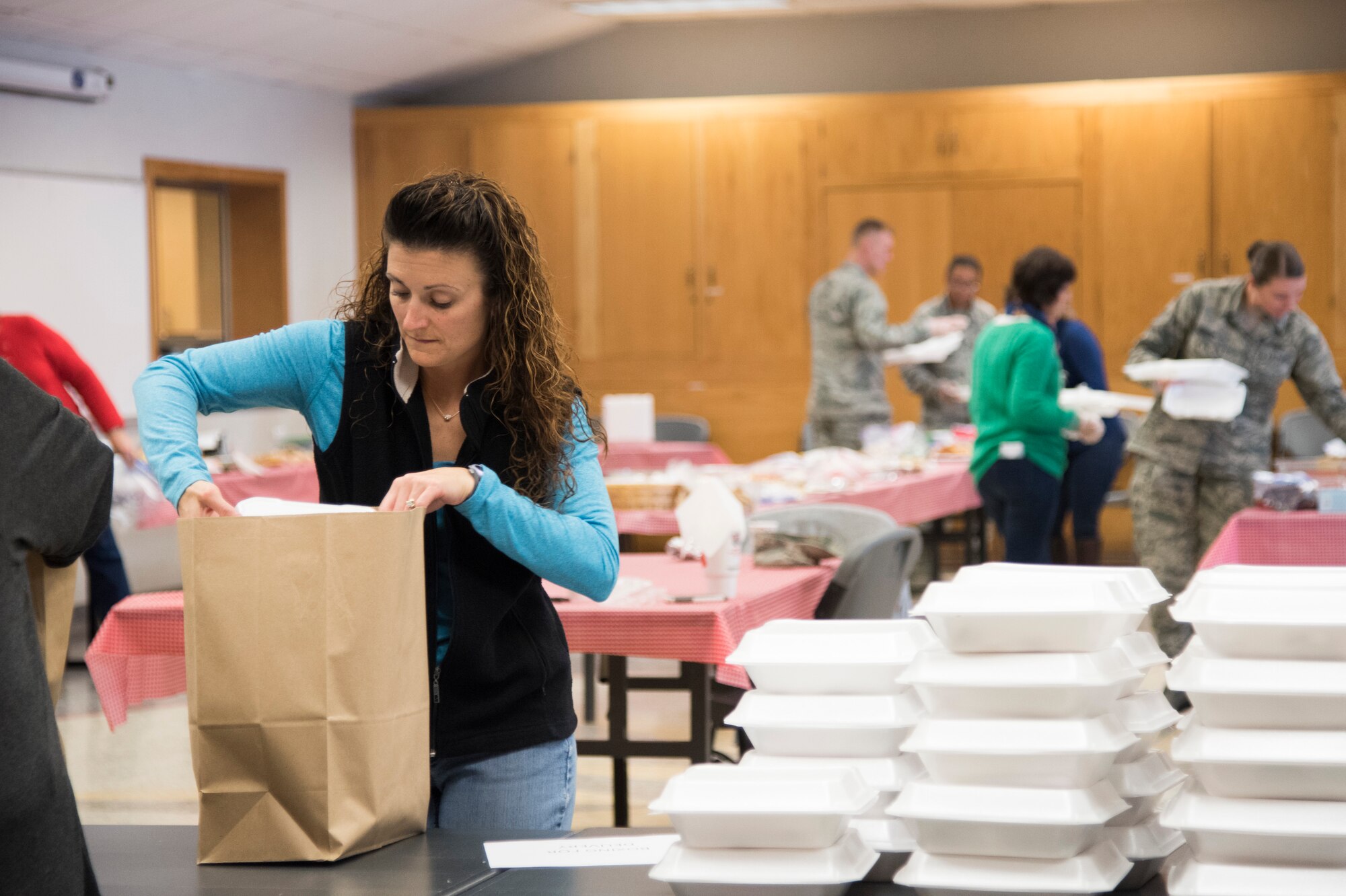 PETERSON AIR FORCE BASE, Colo. – Jennifer Dorminey, wife of Col. Eric Dorminey, 21st Space Wing vice commander, bags packages of cookies at the Peterson Chapel on Dec. 8, 2015 for the dorm residents and those on shift work during the holidays. The annual cookie drive was hosted by the Peterson, Schriever and Cheyenne Mountain Spouses’ Club. (U.S. Air Force photo by Senior Airman Tiffany DeNault)