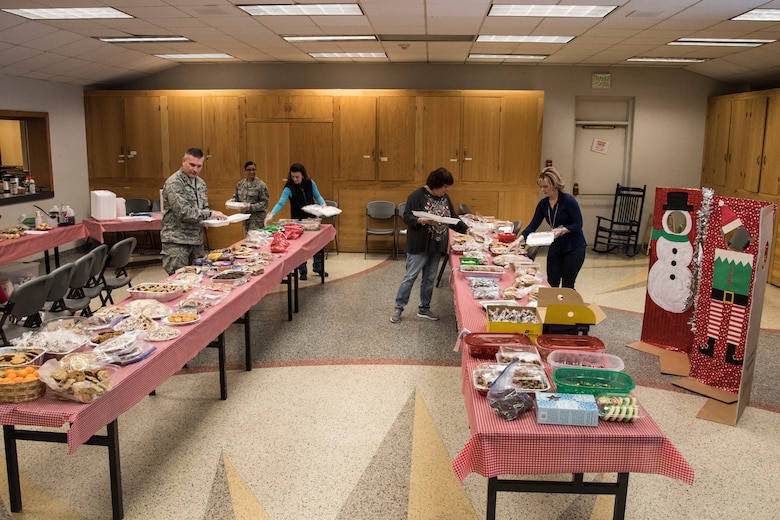 PETERSON AIR FORCE BASE, Colo. –  21st Space Wing leadership and members of the Peterson, Schriever, and Cheyenne Mountain Spouses’ Club package cookies at the Peterson Chapel on Dec. 8, 2015. Hosted by the PSC Spouses’ Club, the annual “Cookies for the Troops” event collected cookies and other holiday treats for the dorm residents and those on shift work during the holiday season. (U.S. Air Force photo by Senior Airman Tiffany DeNault)