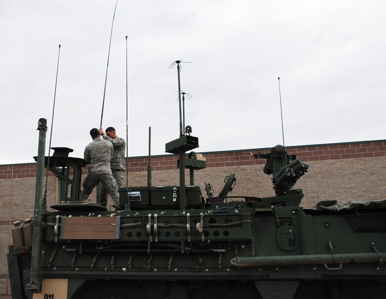 FORT CARSON, Colo. - Two members of the 13th Air Support Squadron Tactical Air Control Party install a large whip antennae on a Stryker combat vehicle. Team members are on a continuous cycle of training and deploying in support of the 4th Infantry Division at Ft. Carson where the squadron is located. (U.S. Air Force Photo by Dave Smith)