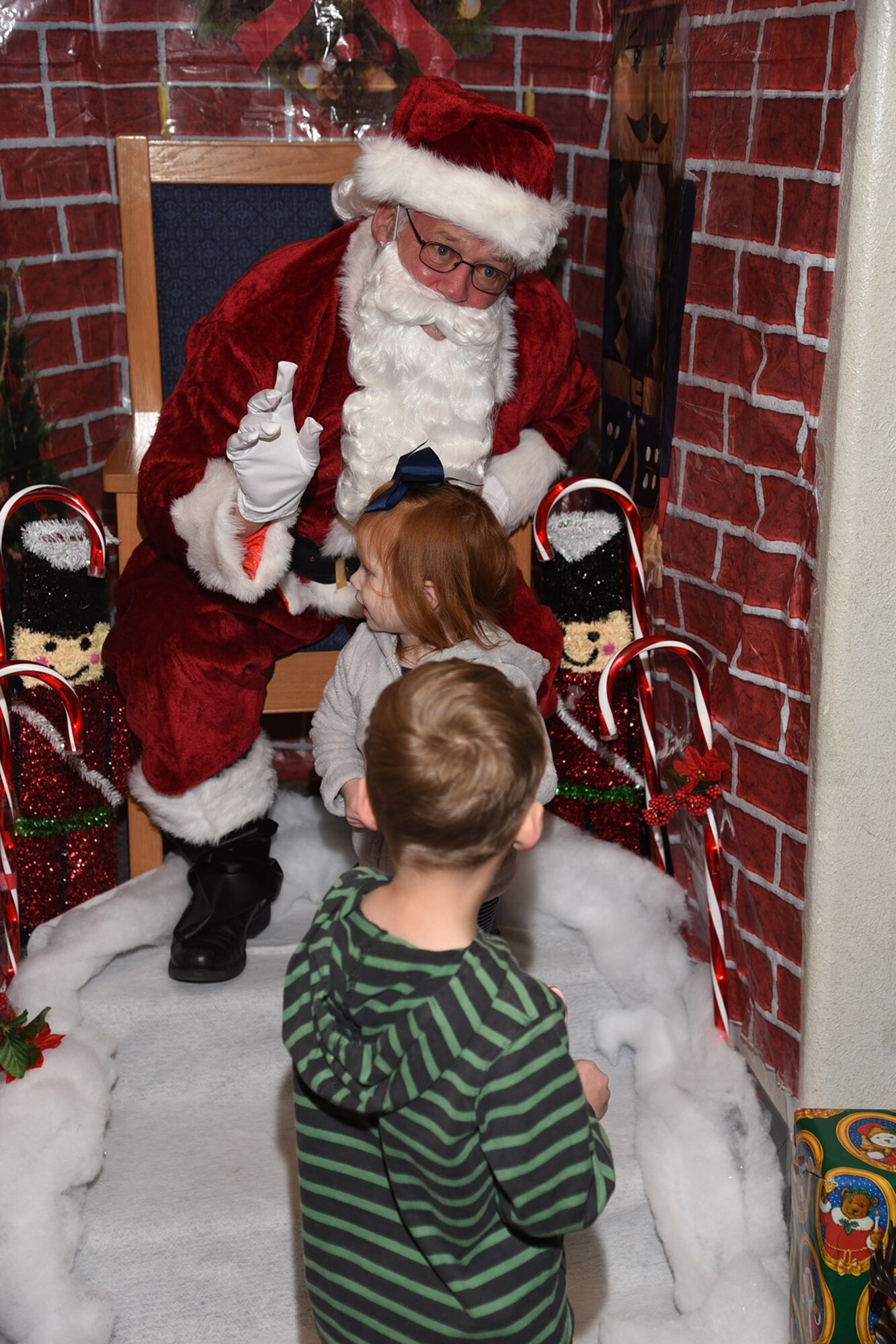 PETERSON AIR FORCE BASE, Colo. - Peterson children visit with Santa Claus during the Holiday Tree lighting ceremony Dec. 4, 2015. The Peterson Chapel sponsored the ceremony and hosted the Deployed Families Dinner following the tree lighting. (U.S. Air Force photo by Robb Lingley)
