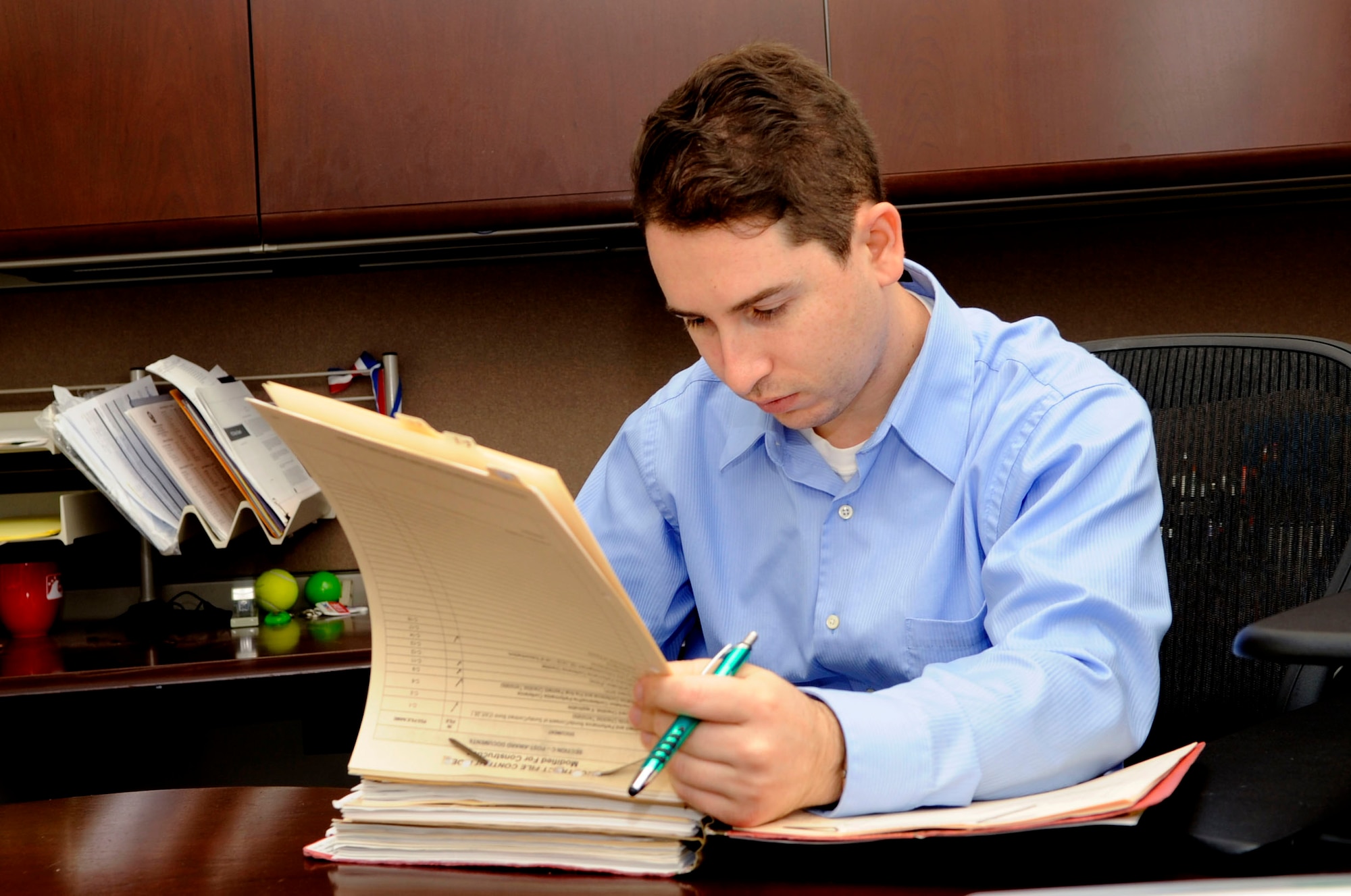 Jeffrey Grelck, 30th Contracting Squadron contracting officer, reviews a contract modification for compliance with regulations, Dec. 9, 2015, Vandenberg Air Force Base, Calif. At VAFB a primary mission is achieving successful polar-orbital launches – which are often essential to upholding U.S. dominance in space and could not happen without dedicated personnel from various organizations, like the members of the 30th Contracting Squadron. (U.S. Air Force photo by Senior Airman Shane Phipps/Released)