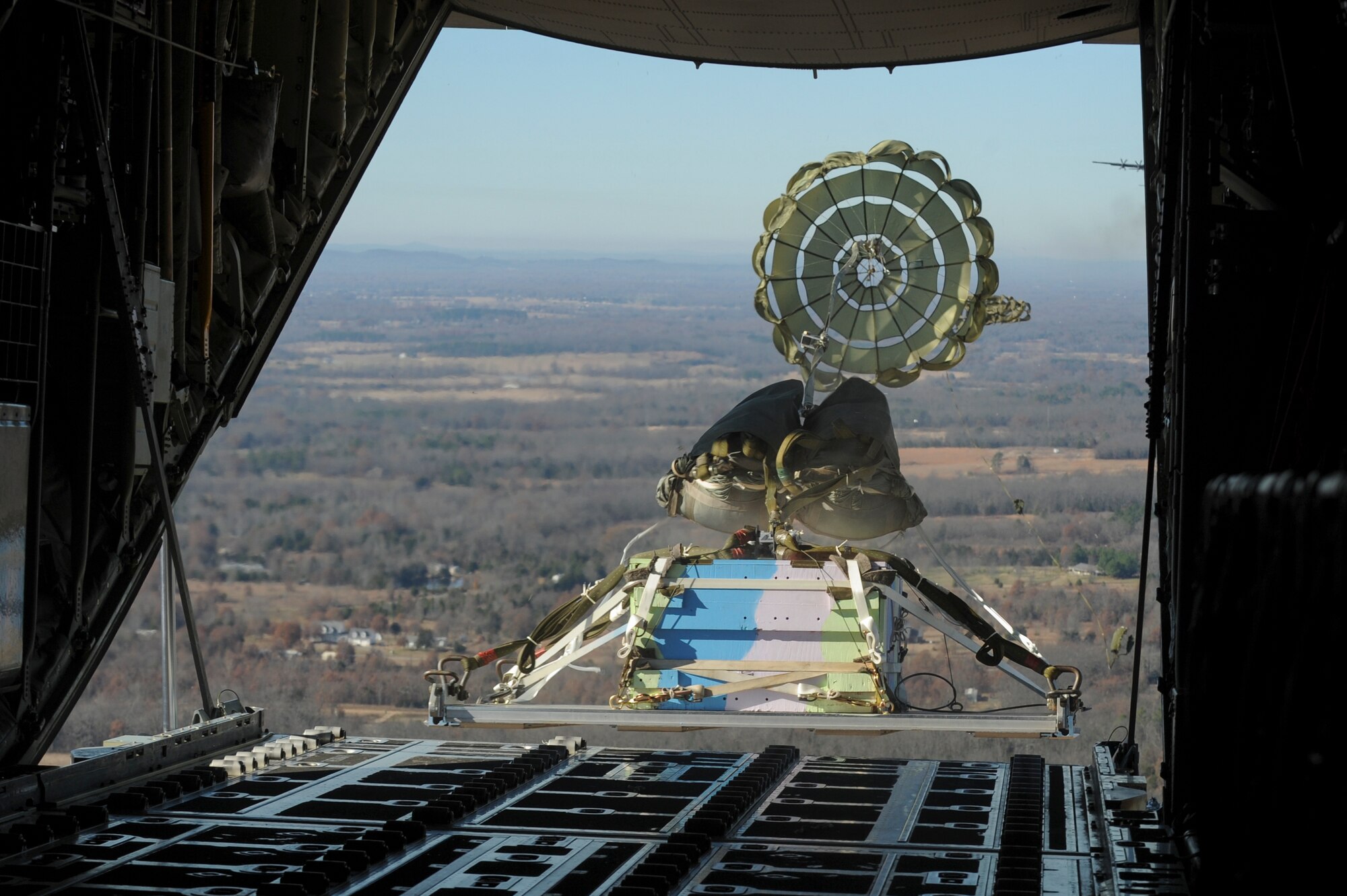A C-130J drops a cargo pallet during the Chosin Reservoir remembrance flight Dec. 7, 2015, near Central Arkansas. The drops symbolized the bridge sections that were dropped during the Korean War in 1950. (U.S. Air Force photo by Senior Airman Scott Poe)