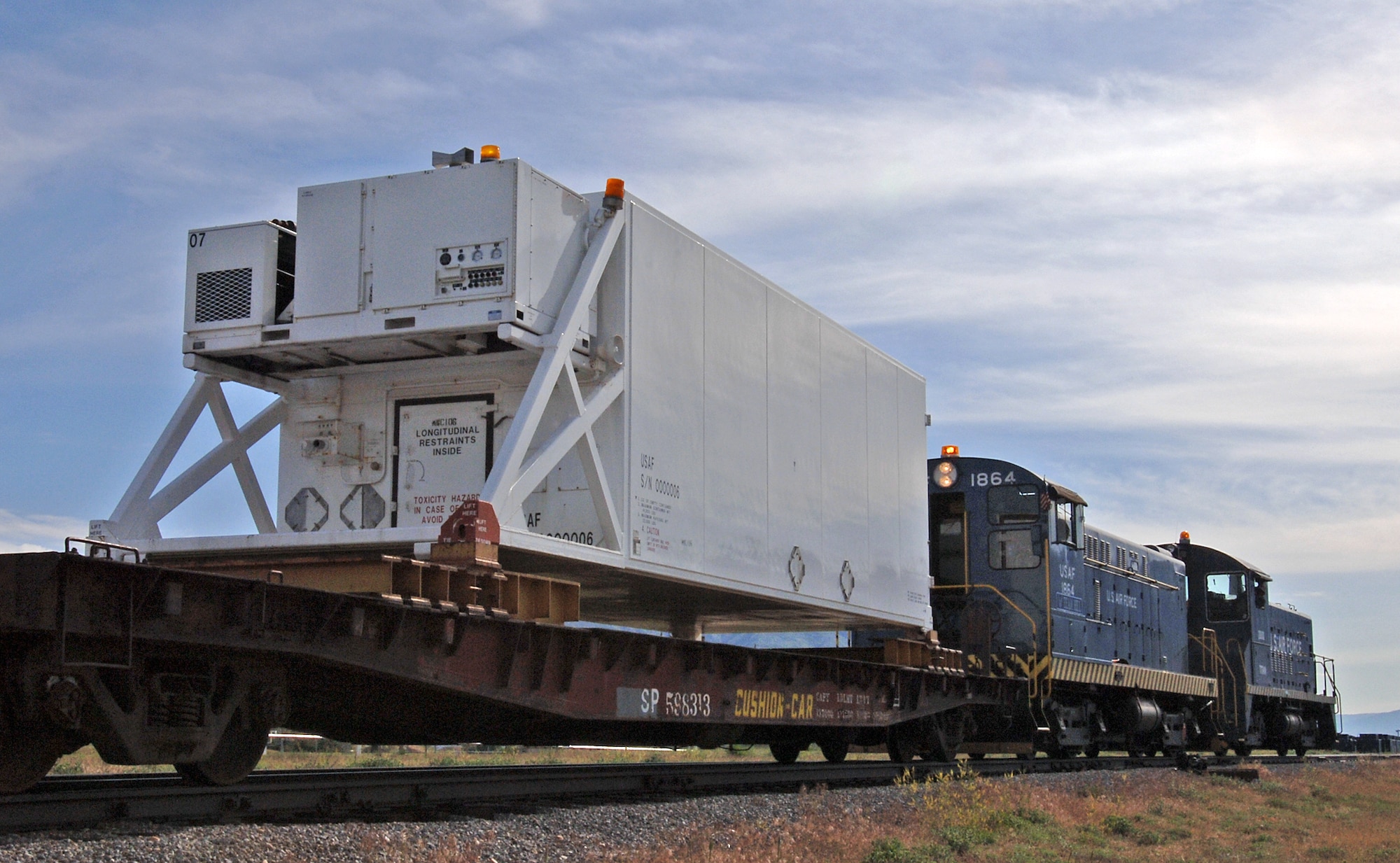 Working in a consist (two or more locomotives working together), U.S. Air Force S12 Switcher 1864 moves a flatcar loaded with a Peacekeeper missile container May 24, 2007, at Hill Air Force Base, Utah. This movement was among 1864’s last before it was parked due to replacement parts becoming unavailable.  (U.S. Air Force photo/Alex R. Lloyd)