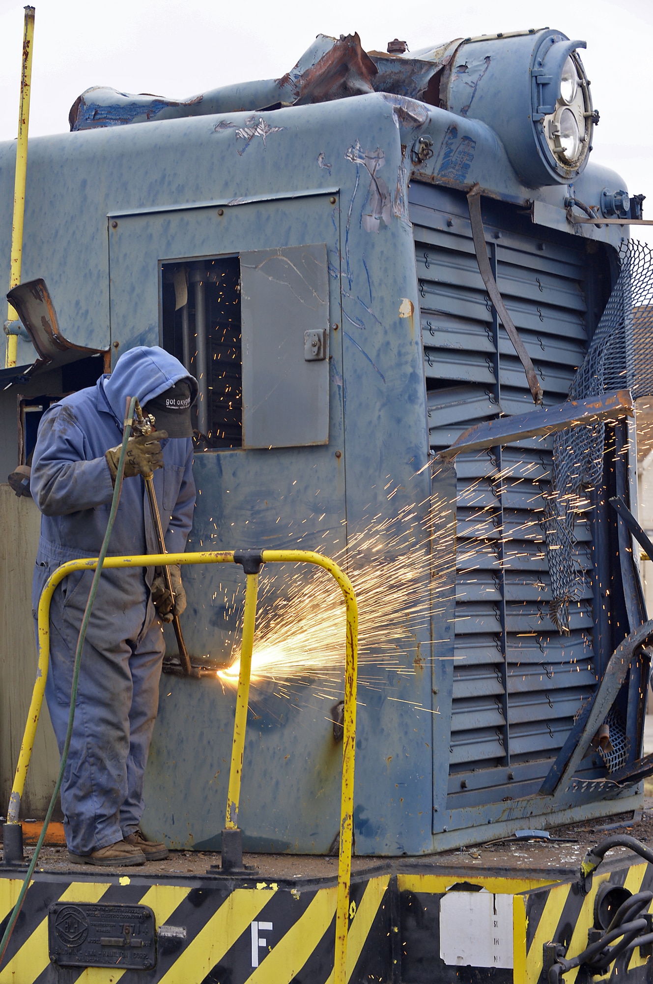 Jose Alvino cuts U.S. Air Force S12 Switcher 1864’s sheet metal using an oxygen-propane torch at Hill Air Force Base, Utah, Nov. 10, 2015. Once removed, the sheet metal will be recycled by Allied Metals in Ogden, Utah.  (U.S. Air Force photo/Alex R. Lloyd)