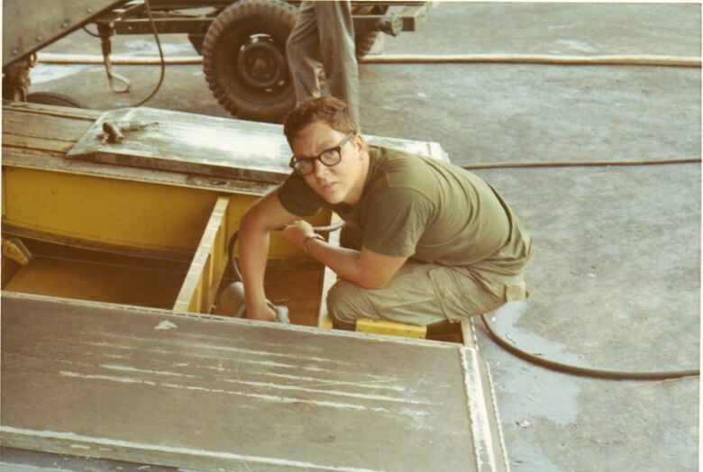 Specialist 4 Rod Smith hard at work in Vietnam , as seen here repairing the tail ramp of a CH-47C Chinook helicopter at Phu Loi , South Vietnam circa 1971-1972.  (Courtesy Rod Smith)