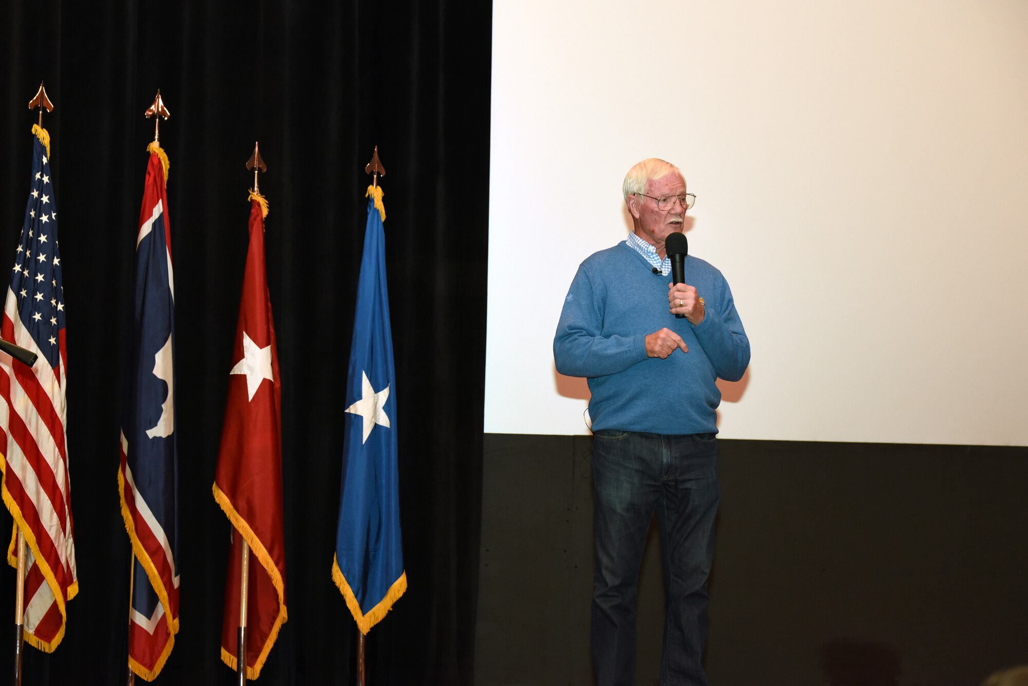 Retired U. S. Air Force Col. Ed Hubbard speaks to 153rd Airlift Wing members, Dec. 5, 2015 at F.E. Warren AFB in Cheyenne, Wyoming. Hubbard detailed his experiences as a POW and provided insight on keeping a positive attitude during captivity. (U.S. Air National Guard photo by Tech. Sgt. John Galvin/released)
