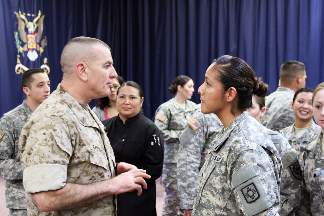 Marine Sgt. Maj. Bryan B. Battaglia, senior enlisted advisor to the chairman of the Joint Chiefs of Staff, spoke to a large gathering of New Mexico National Guard members at the 515th Regional Training Institute in Santa Fe., N.M.,  March 8, 2015. Battaglia speaks with Staff Sgt. Shannon Osborne, an IT professional, about her dual role as a Master Resiliency Trainer and the future of the Resiliency program as a whole. U.S. Army photo by Sgt. John A. Montoya Jr.