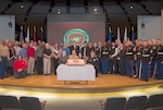 Current and former Marines from the Columbus area pose for a group photo at the Marine Corps’ 240th Birthday Celebration inside the Building 20 auditorium on Defense Supply Center Columbus Nov. 10.