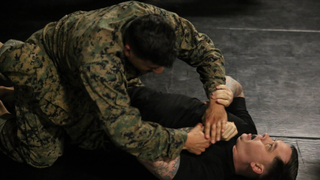 A student in the Martial Arts Instructor Course grapples with Staff Sgt. Roger Nelson, the chief instructor of the course, during a training session at Marine Corps Base Camp Lejeune, N.C., Dec. 4, 2015. The three-week long course will qualify its students to be Martial Arts instructors. The course’s development of endurance, strength, fighting ability and knowledge will benefit Marines for future operations in any location. (U.S. Marine Corps photo by Cpl. Paul S. Martinez/Released)