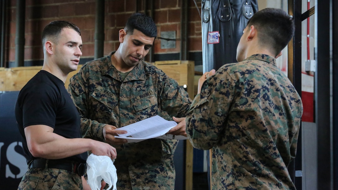 Marine students undergoing the Martial Arts Instructor Course review course material following a training session at Camp Lejeune, N.C., Dec. 4, 2015. The three-week long course will qualify its students to be Martial Arts instructors. The course’s development of endurance, strength, fighting ability and knowledge will benefit Marines for future operations in any location. 