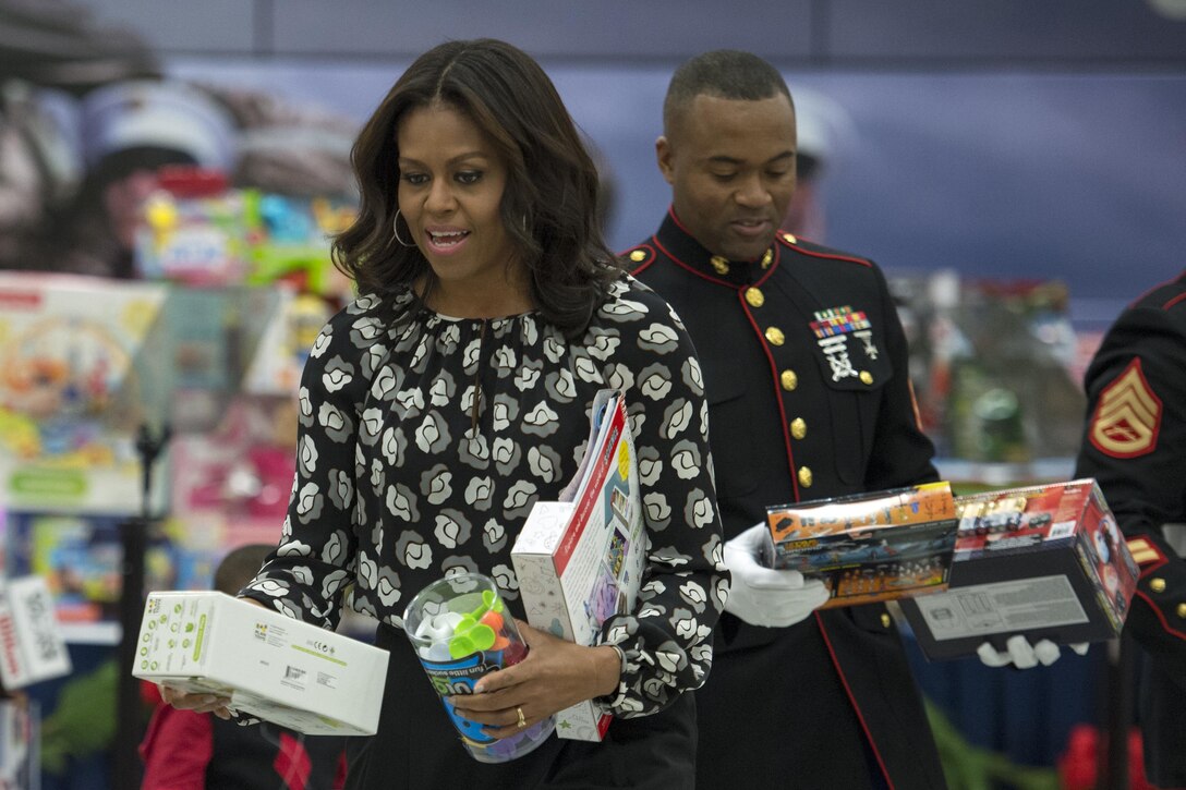 First Lady Michelle Obama and a Marine sort toys during a Toys for Tots event on Joint Base Anacosta-Bolling in Washington, D.C., Dec. 9, 2015. DoD photo by EJ Hersom