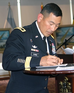 Maj. Gen. K.K. Chinn, commanding general of U.S. Army South, signs the Conference of the American Armies accords Nov. 19 in Bogota, Colombia. The CAA was founded in 1960 and is a military organization of 20 member armies from the American continents. Each of the 18 senior army commanders present took turns to sign the accords, signifying their acceptance of agreed upon actions during the next two-year cycle that the U.S. will host for the first time in 24 years.