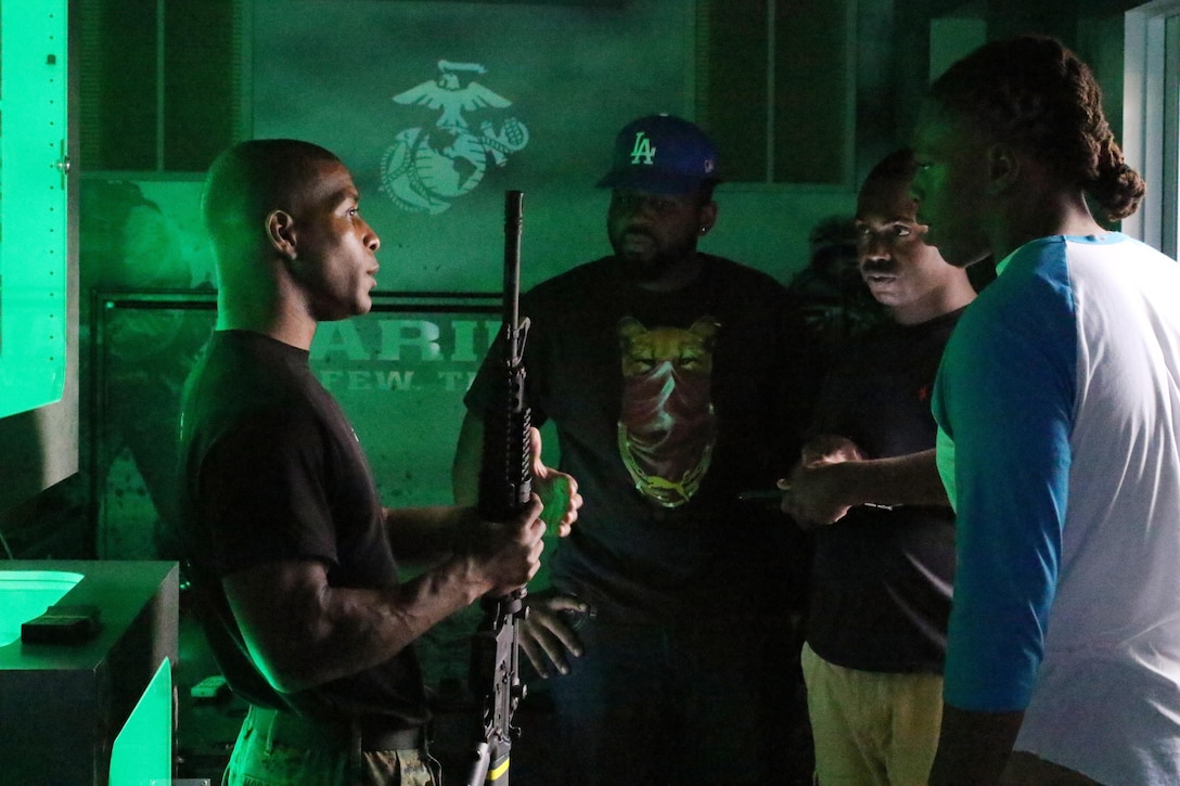 Sergeant Jamall McDowell, 6th Marine Corps Recruiting District enhanced marketing vehicle team recruiter, speaks to prospects during the Bayou Classic 2015 Fan Festival at Champions Square of the Mercedes-Benz Superdome on Nov. 28, 2015. During the Festival, the Marine Corps had a booth setup to include the Indoor Simulated Marksmanship Trainer, recruitment table and pull-up challenge. (U.S. Marine Corps photo by Sgt. Rubin J. Tan/Released) 