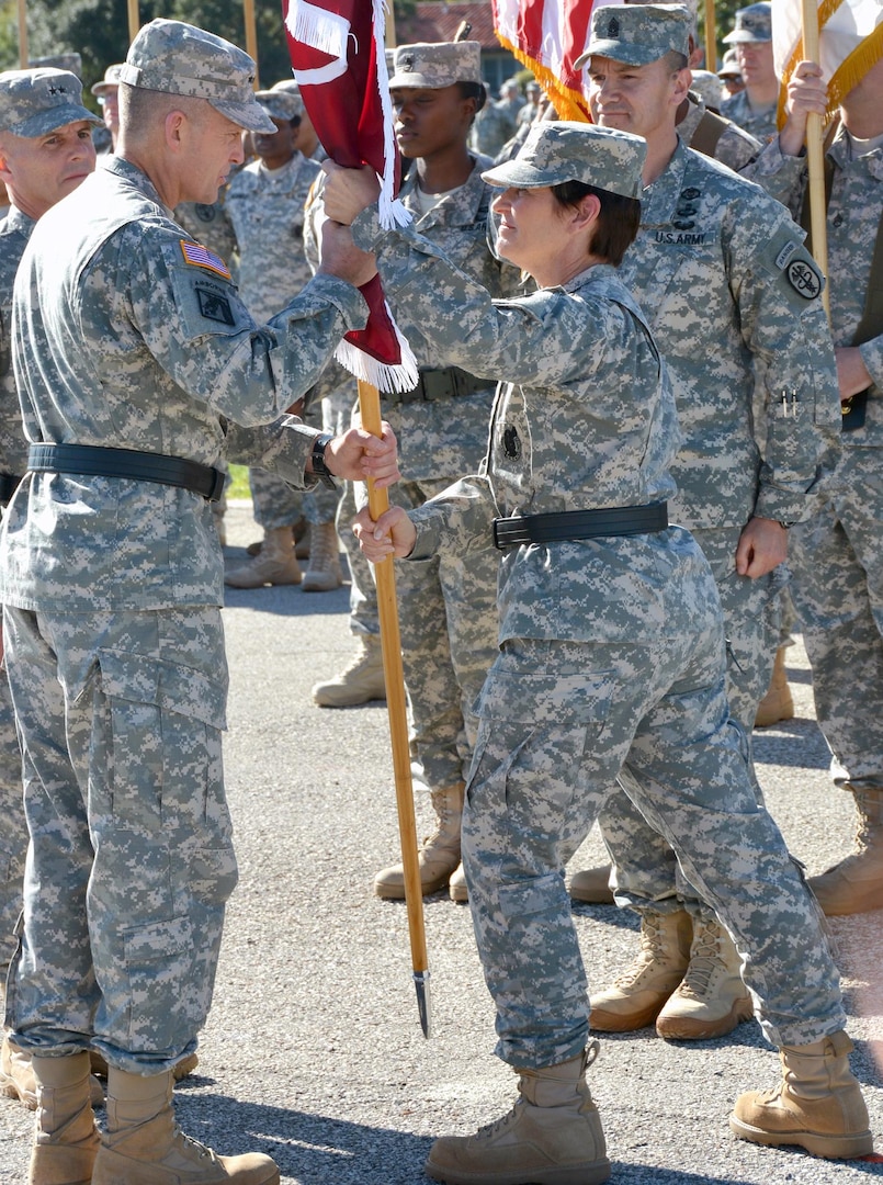 Army vice chief of staff Gen. Daniel B. Allyn (left) accepts the U.S. Army Medical Command colors from outgoing Army surgeon general and commanding general of the U.S. Army Medical Command Lt. Gen. Patricia D. Horoho during her relinquishment of command ceremony at MacArthur Parade Field on Fort Sam Houston Dec. 3.