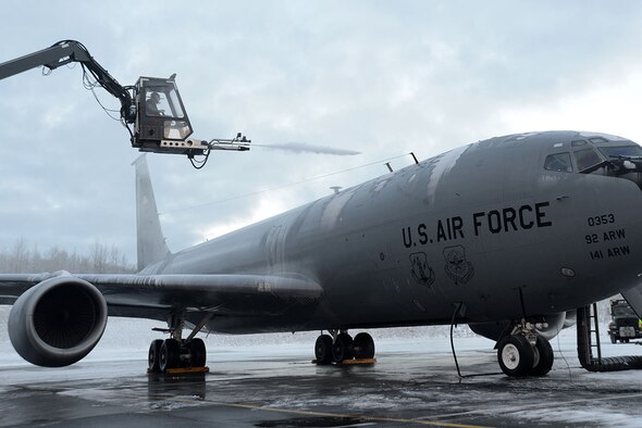Staff Sgt. Tyler Derr, a 732nd Air Mobility Squadron avionics specialist, deices a KC-135 Stratotanker from Fairchild Air Force Base, Wash., on the flightline at Joint Base Elmendorf-Richardson, Alaska, Dec. 3, 2015. There is always a person in the truck, one in the deicer and one on the ground to make sure the aircraft is deiced all around. (U.S. Air Force photo/Airman 1st Class Christopher R. Morales)