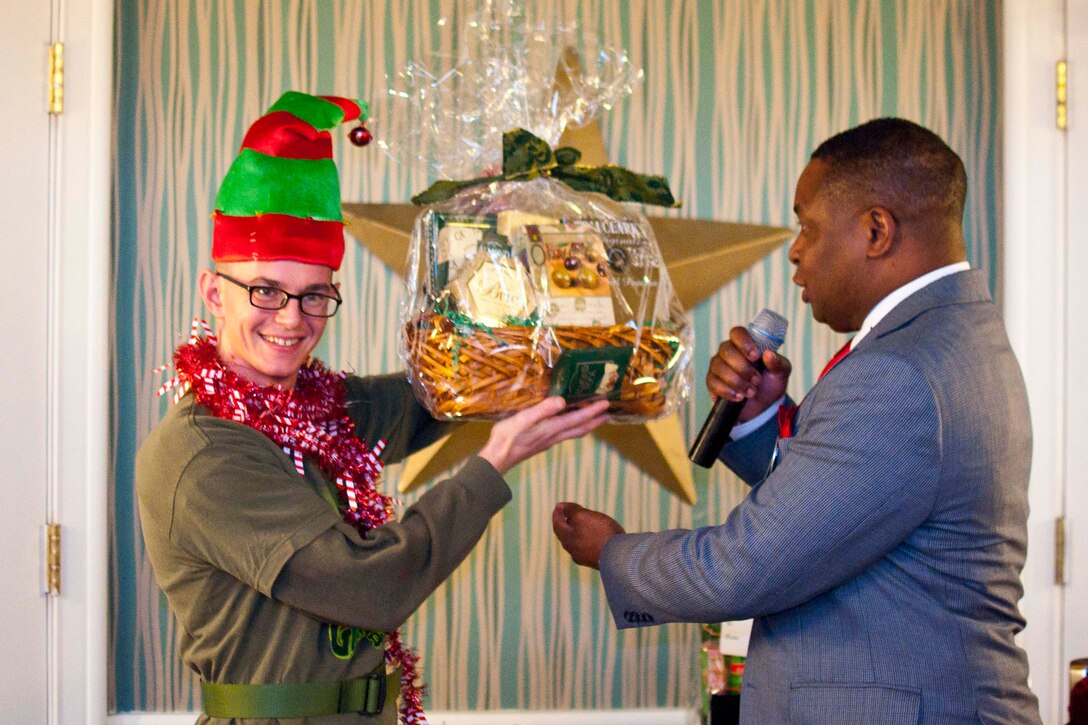 Mike Moore, right, Marine Corps Community Service Single Marine Program coordinator, honors Sgt. Brian Murphy, Reserve Affairs Administration Personnel, for his entry into the elf costume contest Dec. 2 during the base commander’s annual Christmas Troop Appreciation, which was held for sergeants and below at The Clubs at Quantico Crossroads Events Center aboard Marine Corps Base Quantico.