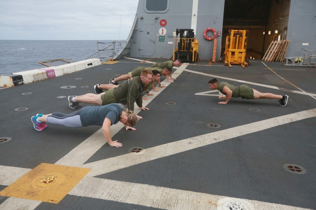 PACIFIC OCEAN (Dec. 7, 2015) U.S. Marines with 1st Light Armored Reconnaissance Detachment, Battalion Landing Team 3rd Battalion, 1st Marine Regiment, 15th Marine Expeditionary Unit, exercise with family members on the flight deck aboard the USS Anchorage (LPD 23). The 15th MEU is coming to the end of deployment and hosting a Tiger Cruise for family members to showcase life aboard the Anchorage. (U.S. Marine Corps photo by Sgt. Steve H. Lopez/Released)