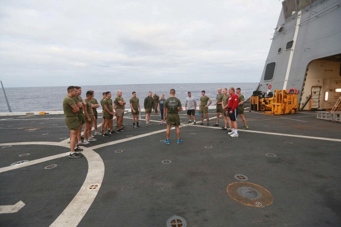 PACIFIC OCEAN (Dec. 7, 2015) U.S. Marines with 1st Light Armored Reconnaissance Detachment, Battalion Landing Team 3rd Battalion, 1st Marine Regiment, 15th Marine Expeditionary Unit, exercise with family members on the flight deck aboard the USS Anchorage (LPD 23). The 15th MEU is coming to the end of deployment and hosting a Tiger Cruise for family members to showcase life aboard the Anchorage. (U.S. Marine Corps photo by Sgt. Steve H. Lopez/Released)