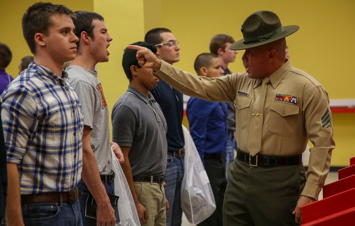 Sergeant Edwin A. Gonzales, senior drill instructor, Receiving Company, Support Battalion, instructs a recruit to respond louder during receiving at Marine Corps Recruit Depot San Diego, Dec. 7. Recruits must respond to everything a drill instructor says to develop instant obedience to orders. During the recruits’ first hours of recruit training, they will get haircuts, receive their initial gear issue and be searched for any contraband. Today, all males recruited from west of the Mississippi are trained at MCRD San Diego. The depot is responsible for training more than 16,000 recruits annually. Echo Company is scheduled to graduate March 4.