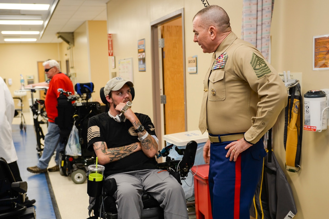 Marine Corps Sgt. Maj. Bryan B. Battaglia, right, senior enlisted advisor to the chairman of the Joint Chiefs of Staff, talks with a wounded warrior at the James A. Haley Veterans' Hospital in Tampa, Fla., Feb. 25, 2015. U.S. Air Force photo by Tech. Sgt. Angelita M. Lawrence