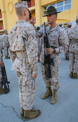 Sergeant Jordan M. Holkey, drill instructor, Golf Company, 2nd Recruit Training Battalion, inspects a recruit’s M16-A4 Service Rifle during a series commander inspection at Marine Corps Recruit Depot San Diego, Dec. 7. Drill instructors search for carbon that builds up on the recruits’ rifles over time. Recruits are given a significant amount of time to clean their rifles every day, if they decide to. Today, all males recruited west of the Mississippi are trained at MCRD San Diego. The depot is responsible for training more than 16,000 recruits annually. Golf Company is scheduled to graduate Jan. 8.