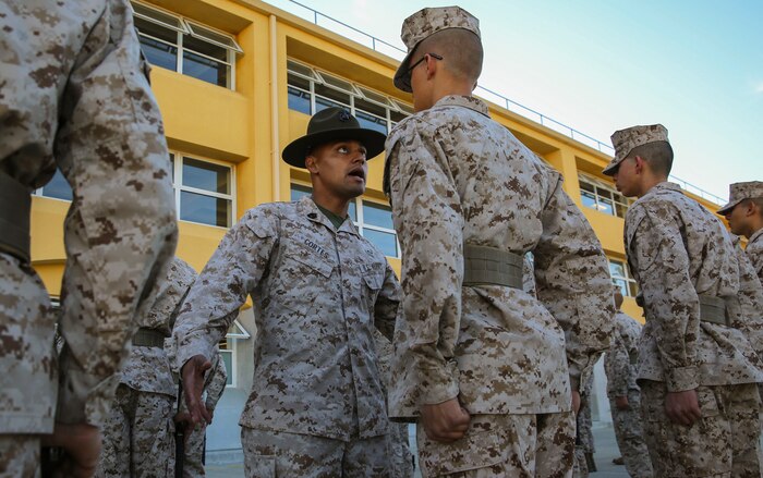 Gunnery Sgt. Miguel Cortes, chief drill instructor, Golf Company, 2nd Recruit Training Battalion, waits for a recruit to respond to a knowledge question during a series commander inspection at Marine Corps Recruit Depot San Diego, Dec. 7. Recruits are expected to answer questions with confidence, even if they forget the answers. There are three inspections the recruits experience before they participate in a battalion commander inspection at the end of training as Marines. Today, all males recruited west of the Mississippi are trained at MCRD San Diego. The depot is responsible for training more than 16,000 recruits annually. Golf Company is scheduled to graduate Jan. 8.