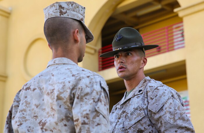 Sergeant Jordan M. Holkey, drill instructor, Golf Company, 2nd Recruit Training Battalion, quizzes a recruit on his knowledge during a series commander inspection at Marine Corps Recruit Depot San Diego, Dec. 7. Drill instructors test recruits to see how much knowledge they’ve absorbed so far in recruit training. Recruits take part in a series of classes to learn about such things as the history of the Marine Corps and uniform standards. Today, all males recruited west of the Mississippi are trained at MCRD San Diego. The depot is responsible for training more than 16,000 recruits annually. Golf Company is scheduled to graduate Jan. 8.