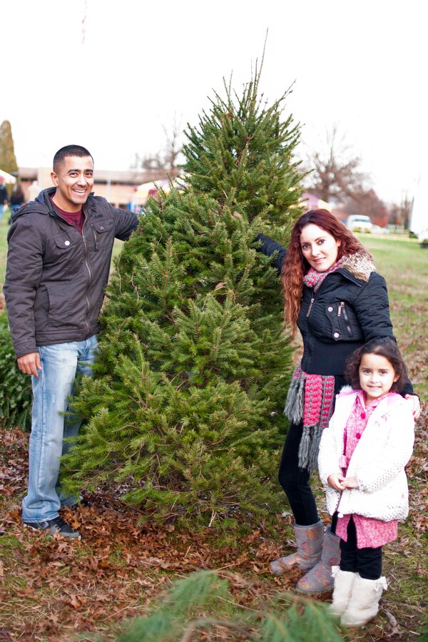 Gunnery Sgt. Ricardo Sola and Nelly Sola pick a holiday tree with their five-year-old daughter Dec. 6 during the Base Christmas Tree Lighting Ceremony at Lejeune Hall. The trees were donated from the Glengary Tree Farm in Amissville, Virginia. This year’s tree lighting event included refreshments, children’s crafts and the appearance of Santa and Mrs. Claus.