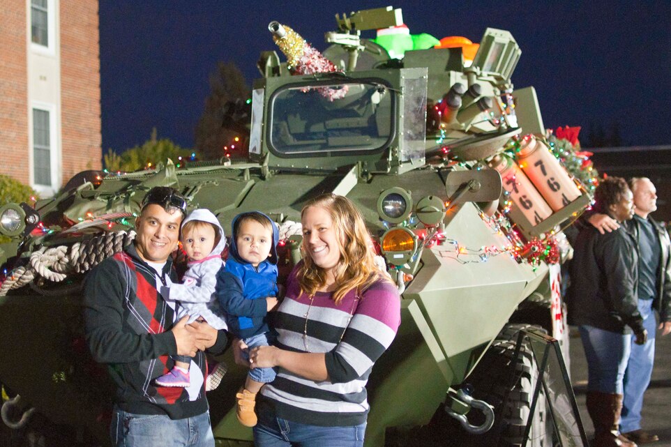 Cpl. Jonathan Figueroa, Marine Corps Ceremonial Platoon detail commander, and Kelly Figueroa bring their two-year-old and one-year-old to the Fifth Annual Base Christmas Tree Lighting Ceremony at Lejeune Hall Dec. 6.