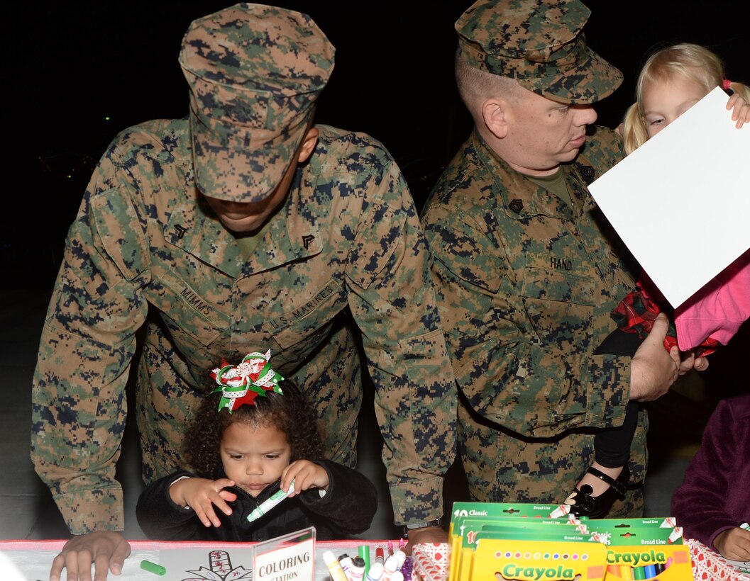 Santa Claus stops by during a Christmas tree lighting ceremony held at Marine Corps Logistics Base Albany, Dec. 8. Other activities during the ceremony included cookie-decorating and picture-coloring stations, elves and a giant gingerbread man mingling with the crowd, Pink Slipper Little Dancers performing dance routines, Westover High School Band playing, Worth County Primary Chorus singing and the Christmas tree lighting. When the lights came on, a snowman began to blow snow into the air and the crowd applauded and cheered.