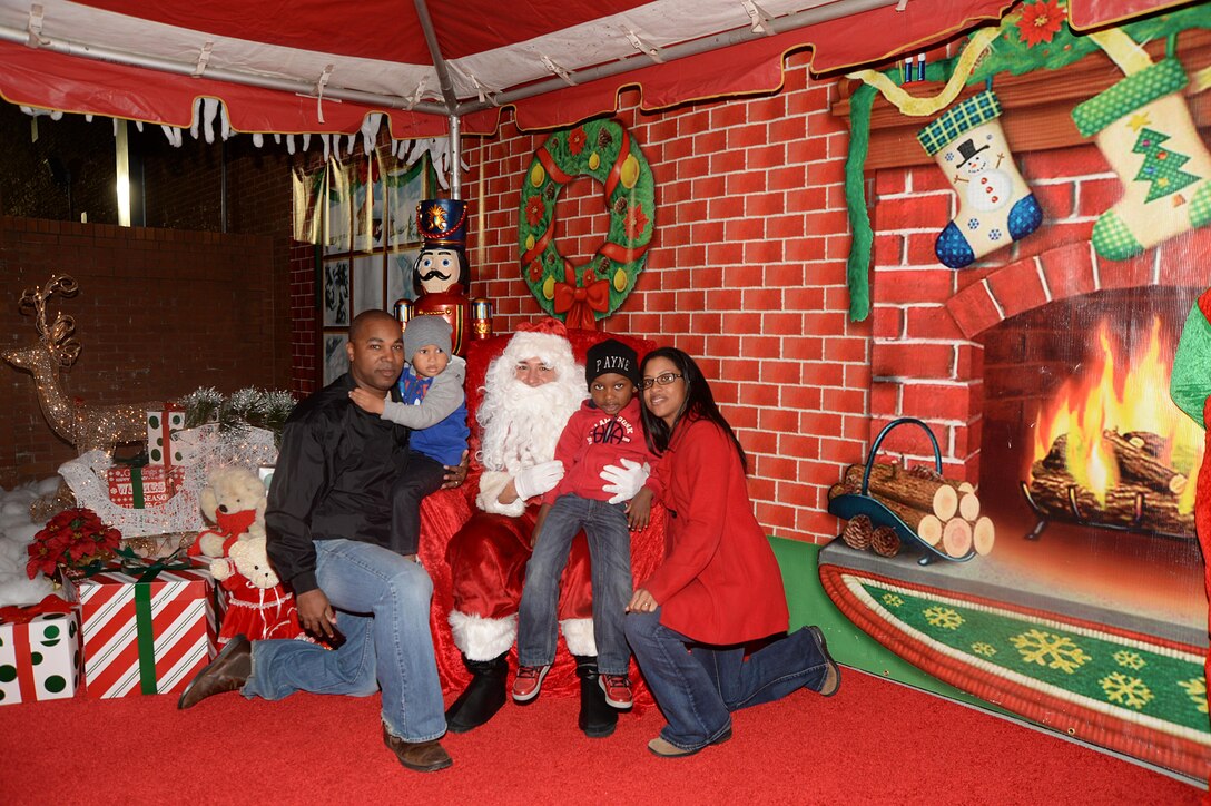 Santa Claus stops by during a Christmas tree lighting ceremony held at Marine Corps Logistics Base Albany, Dec. 8. Other activities during the ceremony included cookie-decorating and picture-coloring stations, elves and a giant gingerbread man mingling with the crowd, Pink Slipper Little Dancers performing dance routines, Westover High School Band playing, Worth County Primary Chorus singing and the Christmas tree lighting. When the lights came on, a snowman began to blow snow into the air and the crowd applauded and cheered.