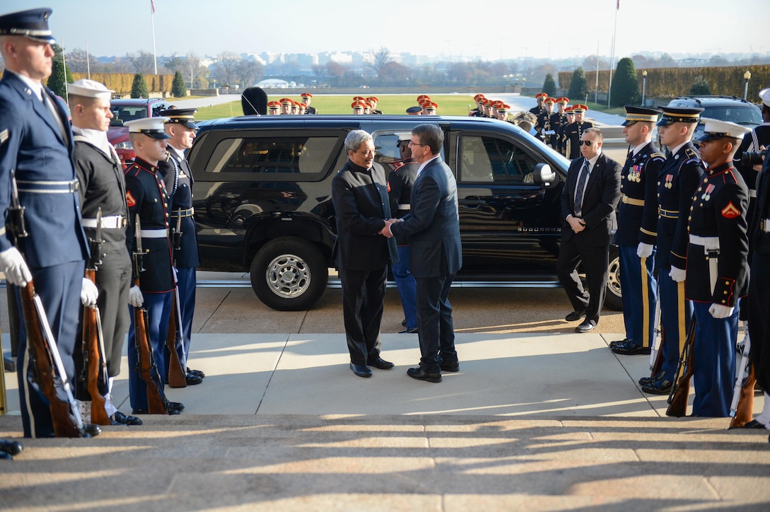 U.S. Defense Secretary Ash Carter, right, welcomes Indian Defense Minister Manohar Parrikar to the Pentagon, Dec. 10, 2015, before hosting an enhanced honor cordon. Both leaders met to discuss matters of mutual importance and held a joint press conference. DoD photo by Army Sgt. First Class Clydell Kinchen