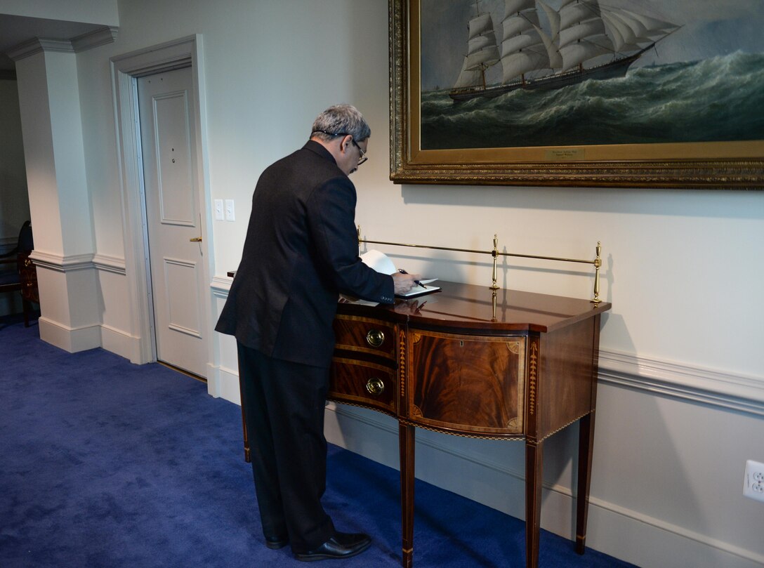 Indian Defense Minister Manohar Parrikar signs a guest book at the Pentagon, Dec. 10, 2015. DoD photo by Army Sgt. First Class Clydell Kinchen
