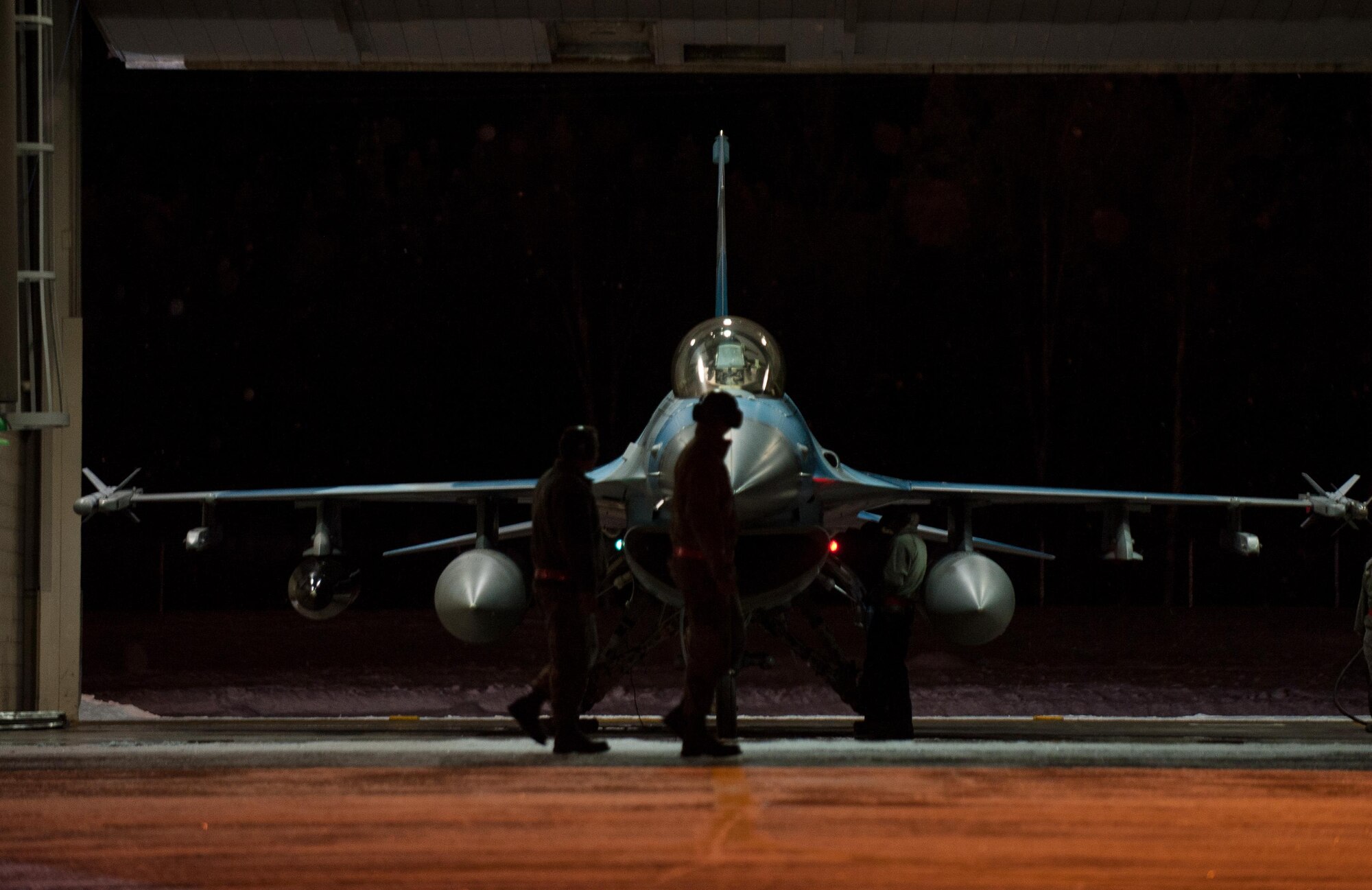 Crew chiefs with the 354th Aircraft Maintenance Squadron perform the last pre-flight checks on an F-16 Fighting Falcon fighter aircraft Dec. 7, 2015, at Eielson Air Force Base, Alaska. More than 30 maintenance Airmen worked an early shift to help launch several jets to Tyndall Air Force Base, Florida, for CHECKERED FLAG 16-1, a large-force exercise that simulates a large number of aircraft in a deployed environment to cross-check weapons systems. (U.S. Air Force photo by Master Sgt. Joseph Swafford/Released)