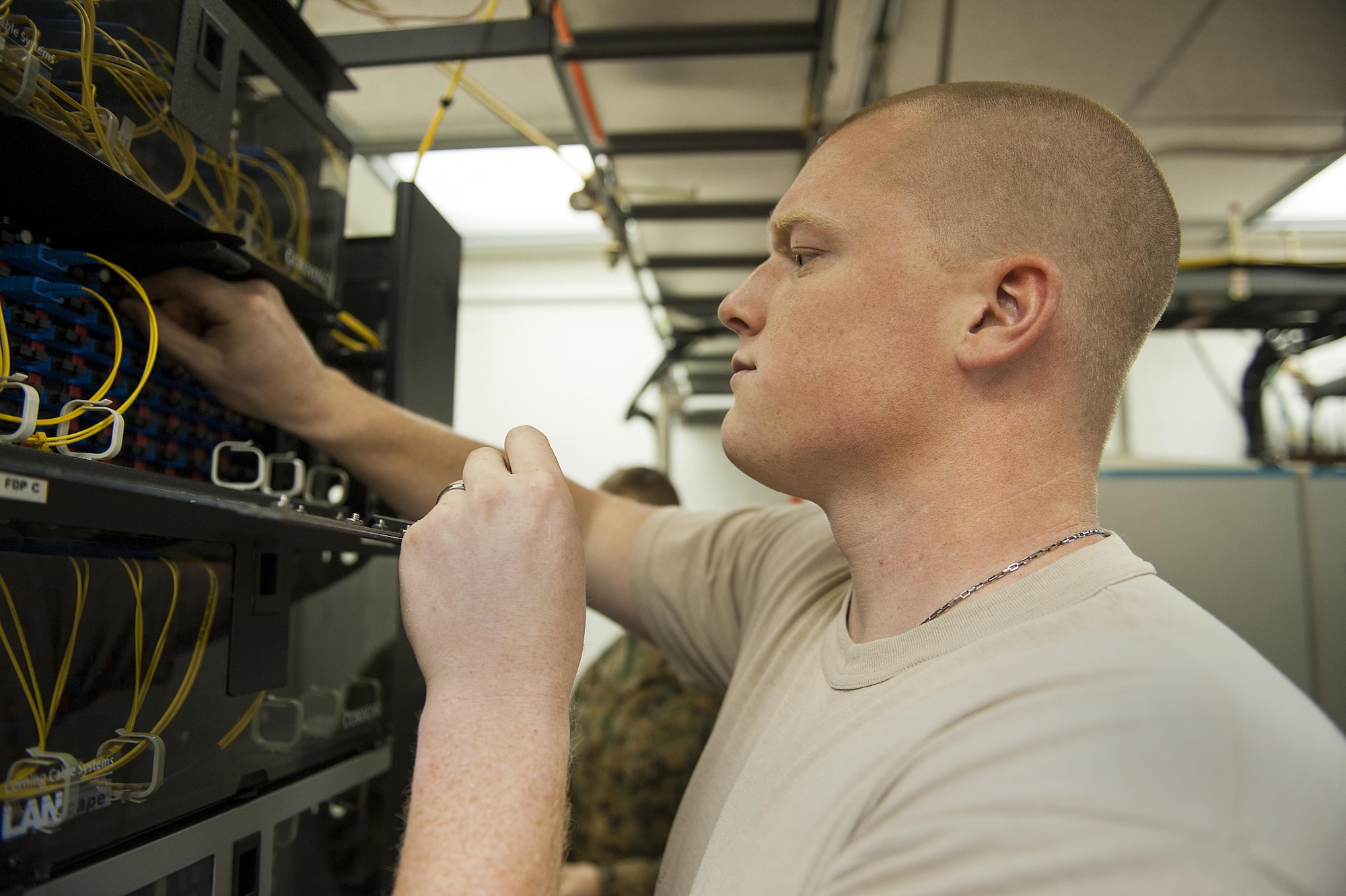 U.S. Air Force Senior Airman Jacob Schroader, 18th Communications Squadron cable and antenna systems journeyman, tests the connection of newly installed wiring Dec. 9, 2015, at Kadena Air Base, Japan. After installing the wires, the specific connections need to be tested to make sure of proper function. (U.S. Air Force photo by Airman 1st Class Corey M. Pettis)