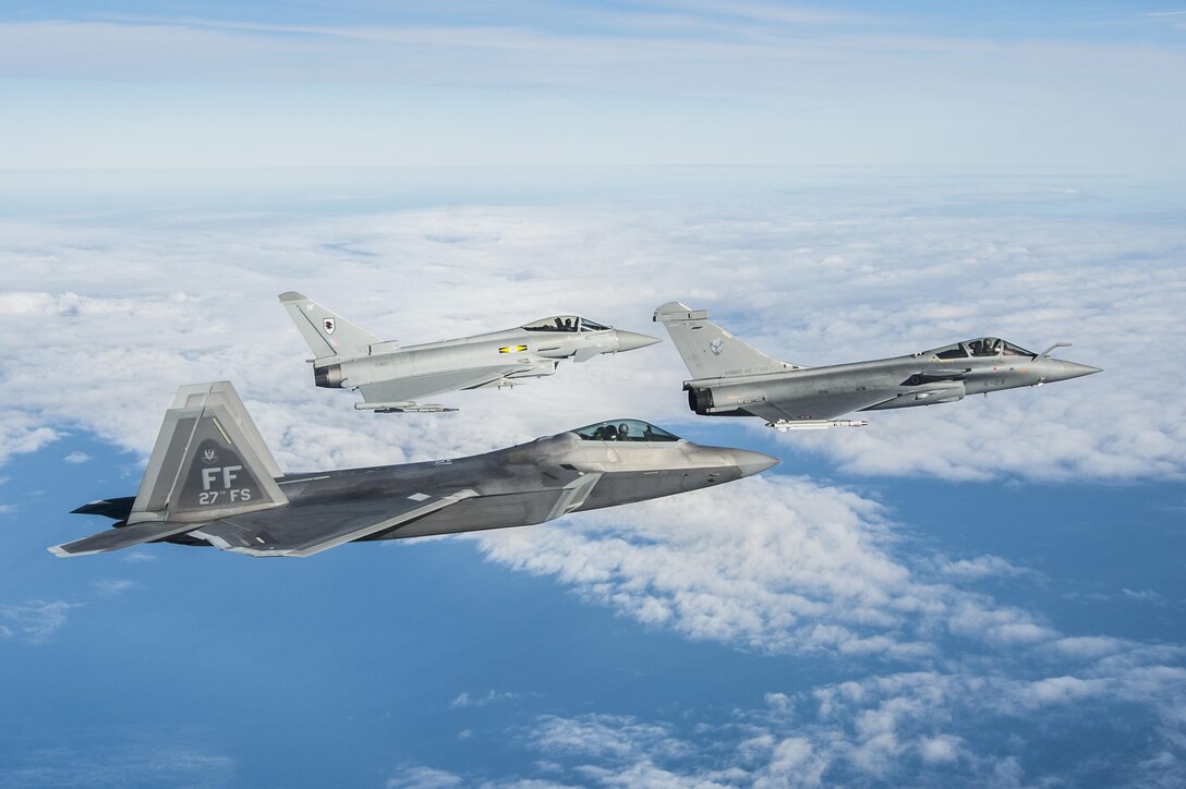An F-22 Raptor, Royal Air Force Typhoon FGR4 and French air force Rafale fly in formation as part of a trilateral exercise held at Joint Base Langley-Eustis, Va., Dec. 7, 2015. The exercise simulates a highly contested, degraded and operationally limited environment where U.S. and partner pilots and ground crews can test their readiness. (U.S. Air Force photo/Senior Airman Kayla Newman)