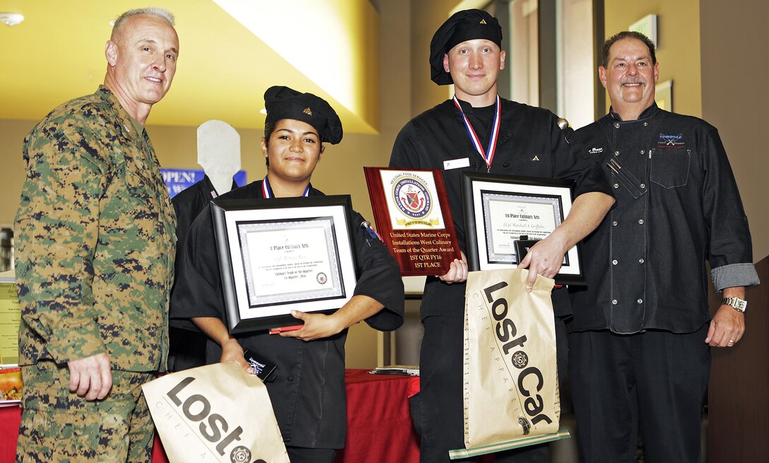 Cpl. Monica Rios and Lance Cpl. Marshall Griffiths, Food Service Specialists, Food service Company, Headquarters Regiment, 1st Marine Logistics Group, pose for a photograph with Col. Jeff Arruda, left, Chief-of-Staff, Marine Corps Base Camp Pendleton, Marine Corps Installations-West and Donovan Brown, right, head chef with Sodexo, after taking first place honors at the MCI-West Chef of the Quarter culinary competition here, Dec. 3. 