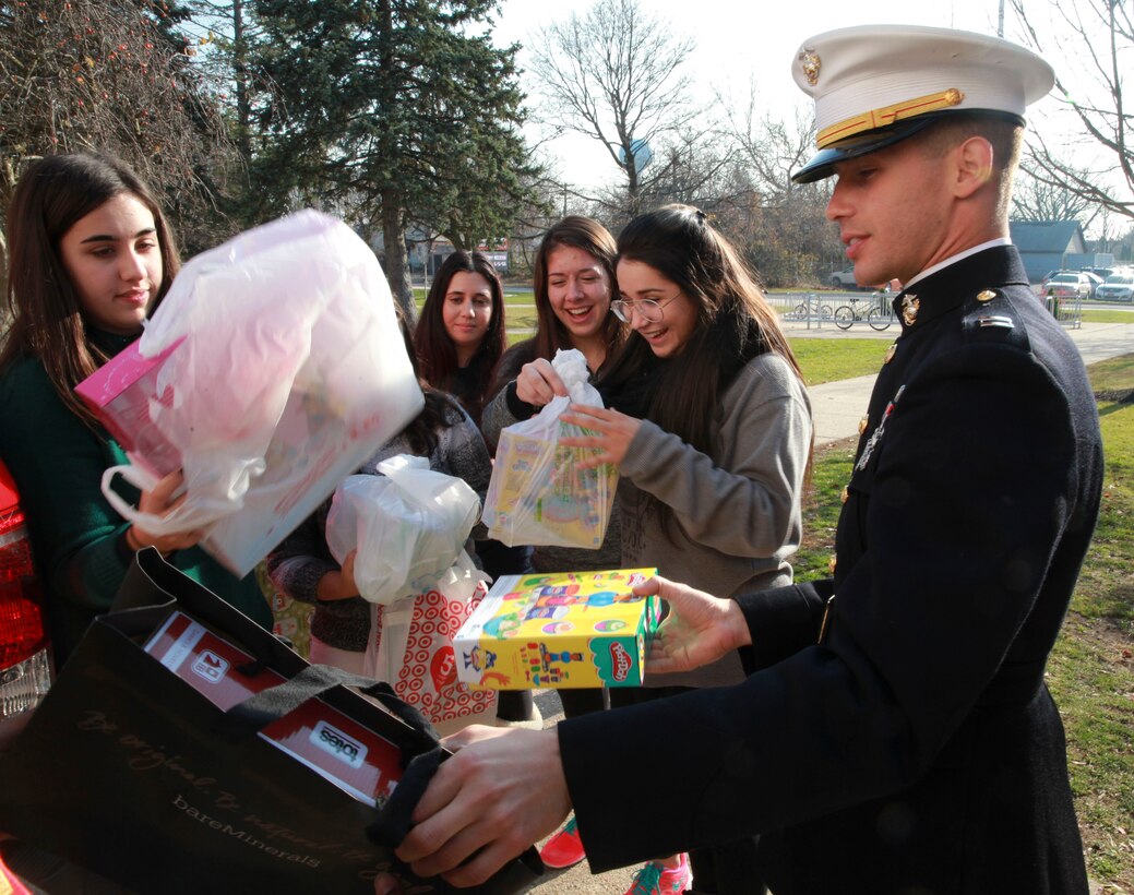 Franklin Square, NY. – Capt. Francisco Pietri, the base operations officer for the 1st Marine Corps District, helps students from H. Frank Carey High School load toys into a truck, Dec. 10. The toys are donations from the seniors of H. Frank Carey High School to kids through the United States Marine Corps Reserve “Toys for Tots” program. 